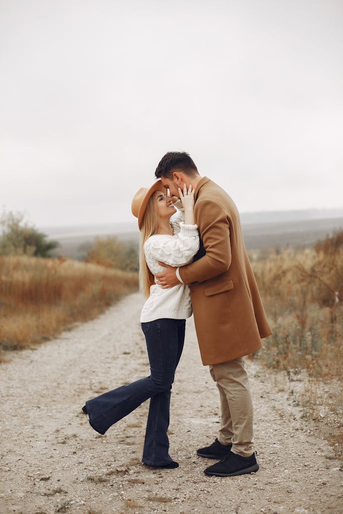 Hugging young couple during date in countryside
